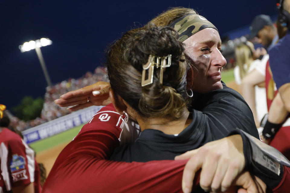 FILE - Oklahoma's Jordyn Bahl, back, hugs associate head coach Jennifer Rocha after the team's win over Florida State in the NCAA Women's College World Series softball championship series Thursday, June 8, 2023, in Oklahoma City. Former Oklahoma softball star Jordy Bahl has returned to her home state to play for Nebraska. (AP Photo/Nate Billings, File)