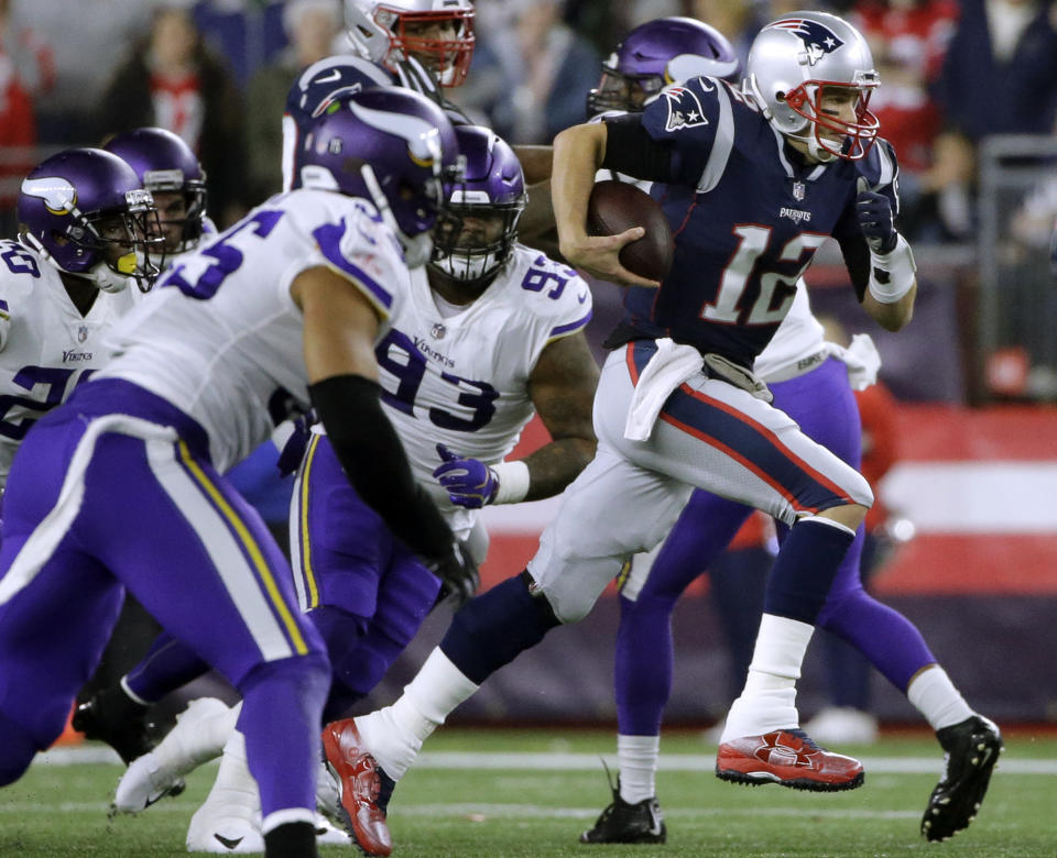 New England Patriots quarterback Tom Brady (12) runs for a first down against the Minnesota Vikings during the first half of an NFL football game, Sunday, Dec. 2, 2018, in Foxborough, Mass. (AP Photo/Steven Senne)