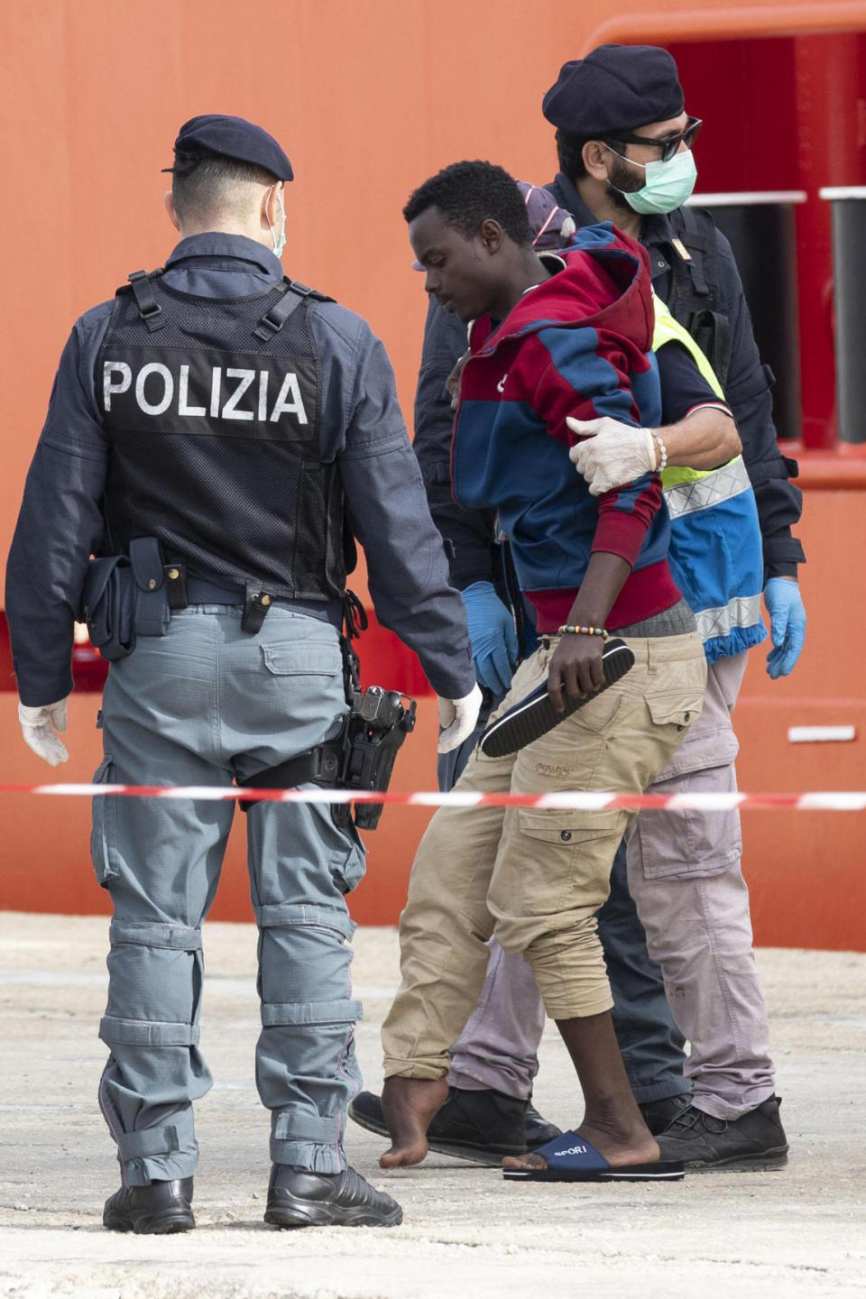 A man is helped to disembark from the Asso Trenta ship, docked in the port of Pozzallo, Italy, Sunday, Nov. 3, 2019. An Italian offshore supply vessel has brought 151 migrants to Sicily after rescuing them in waters off Libya a day earlier. (Francesco Ruta/ANSA via AP)