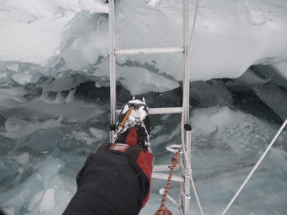 Bull crosses a ladder bridge on the ascent of Everest (Daniel Bull)