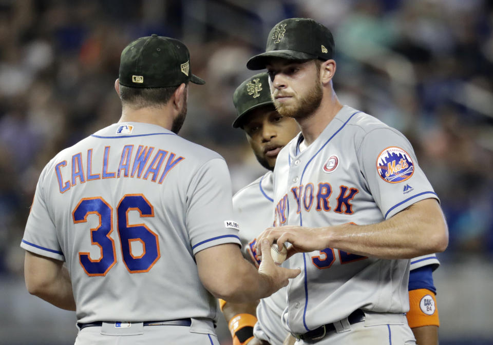 New York Mets starting pitcher Steven Matz, right, hands the ball to manager Mickey Callaway (36) as he is relieved in the fourth inning during a baseball game against the Miami Marlins, Saturday, May 18, 2019, in Miami. (AP Photo/Lynne Sladky)