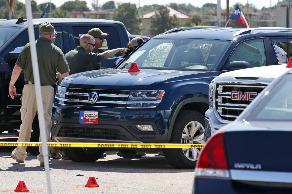 Officials continue to work the scene, Monday, Sept. 2, 2019, in Odessa, Texas, where teenager Leilah Hernandez was fatally shot at a car dealership during Saturday's shooting rampage. (AP Photo/Sue Ogrocki)