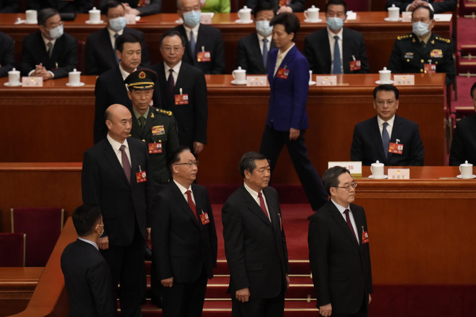 Newly endorsed officials led by Chinese Vice Premier Ding Xuexiang at right line up to take their oaths during a session of China's National People's Congress (NPC) at the Great Hall of the People in Beijing, Saturday, March 11, 2023. (AP Photo/Andy Wong)