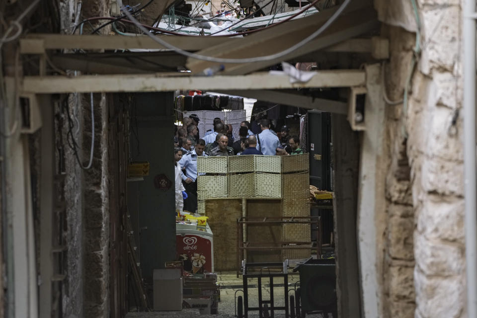 Israeli police examine the scene of a stabbing attack in Jerusalem's Old City, Thursday, Nov. 3, 2022. A Palestinian stabbed a police officer in Jerusalem's Old City, police said, and officers opened fire on the attacker, killing him. The officer was lightly wounded. (AP Photo/Mahmoud Illean)