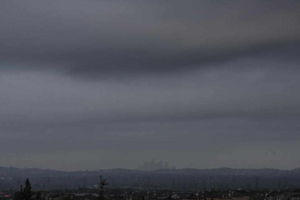 Storm cloud blanket the downtown Los Angeles skyline as seen from Glendora, Calif., Saturday, March 1, 2014. A burst of heavy showers before dawn Saturday impacted wildfire-scarred mountainsides above foothill suburbs east of Los Angeles, causing another round of mud and debris flows in the city of Glendora. (AP Photo/Ringo H.W. Chiu)