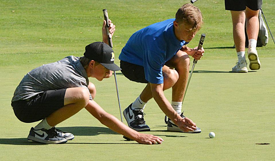 Mitchell's Everett Morrison (left) and Aberdeen Central's Carter Blanchard mark their golf balls during the Watertown Boys Golf Invite on Tuesday, Sept. 19, 2023 at Cattail Crossing Golf Course.