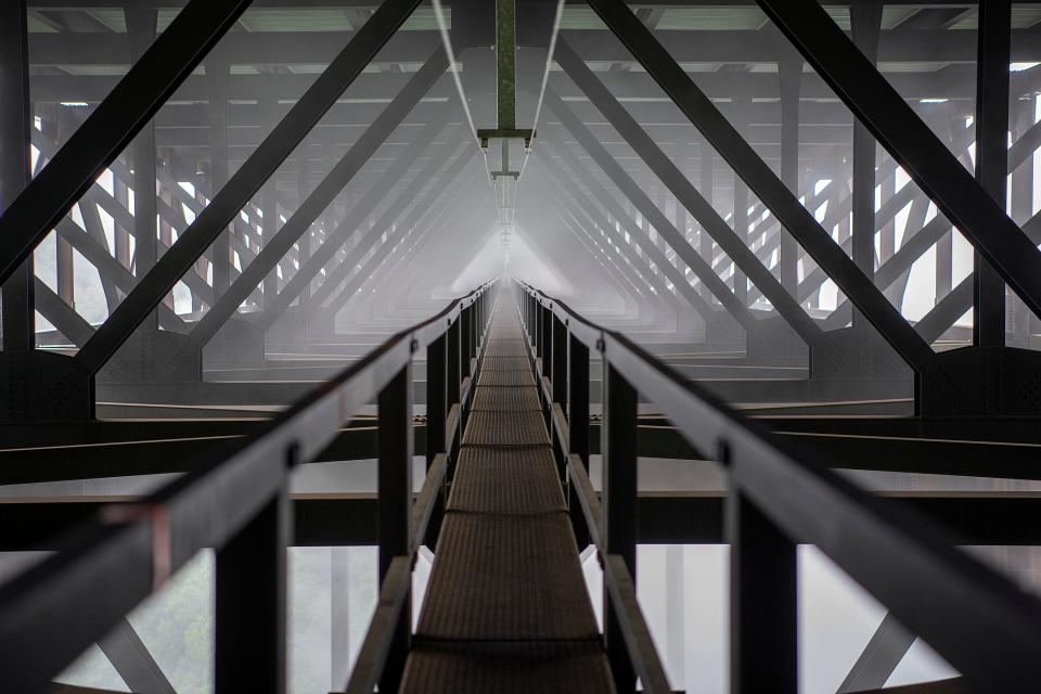 Mid-morning fog creates an ethereal aura on the New River Gorge Bridge, viewed on the Bridge Walk tour.