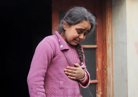 A girls reacts at a site hit by what activists said were two barrels bombs, dropped by forces loyal to Syria's President Bashar al-Assad, in the northwestern Homs district of Al Waer, February 7, 2015. REUTERS/Stringer/Files