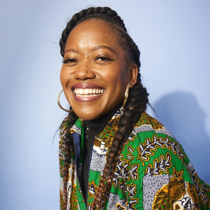 erika alexander smiling with two long braids