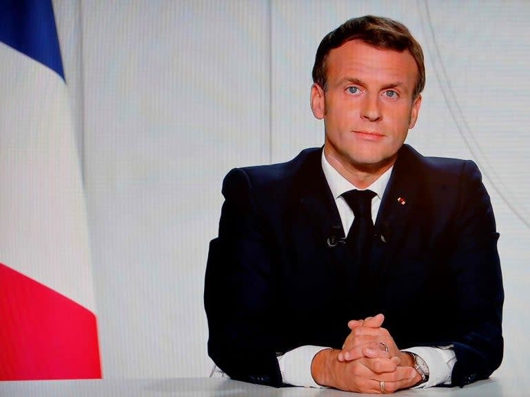 French President Emmanuel Macron is seen on a TV screen in Paris on 28 October, 2020, as he delivers an address announcing new lockdown measures to curb the spread of the Covid-19 pandemic (AFP via Getty Images)