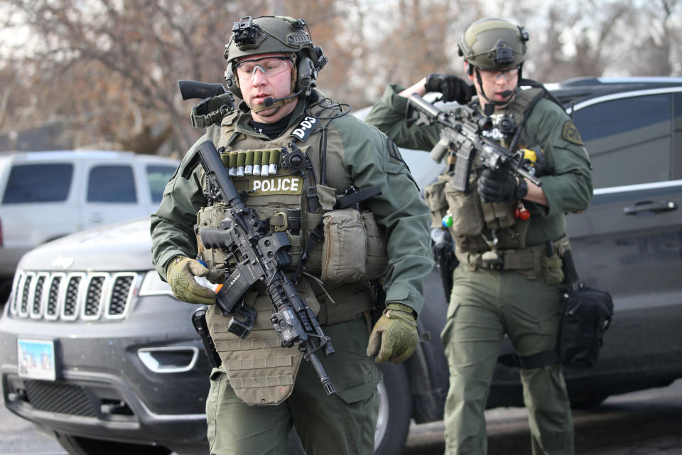 Police officers armed with rifles stage near a commercial building where an active shooter was reported in the 600 block of Archer Avenue in Aurora, Illinois.&nbsp;