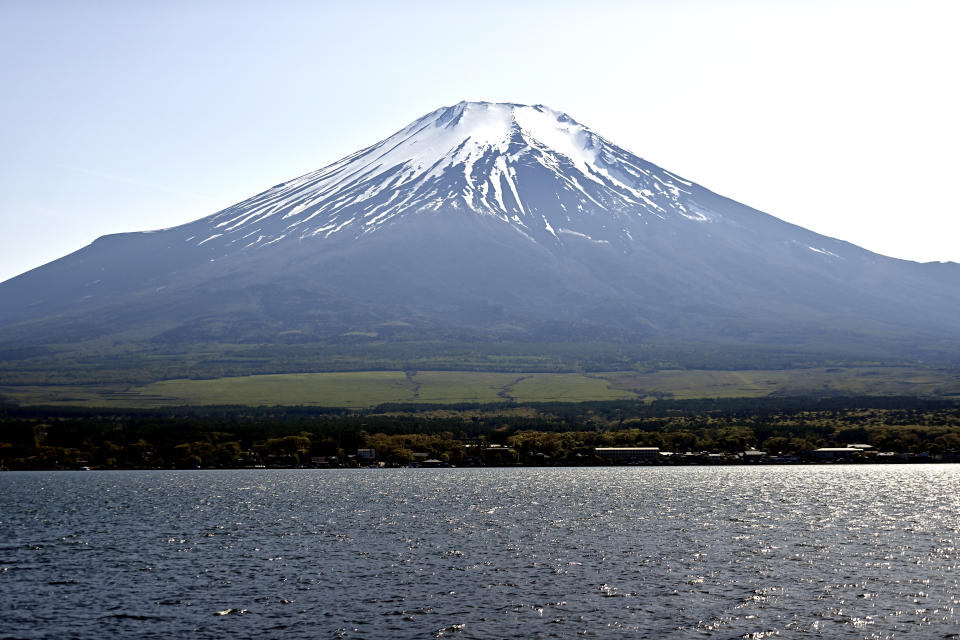 YAMANAKAKO, JAPAN - MAY 10 : A view of Mount Fuji whose summit is covered with its first snow from Yamanakako village on May 10, 2024 in Yamanakako, Yamanashi Prefecture, Japan. (Photo by David Mareuil/Anadolu via Getty Images)