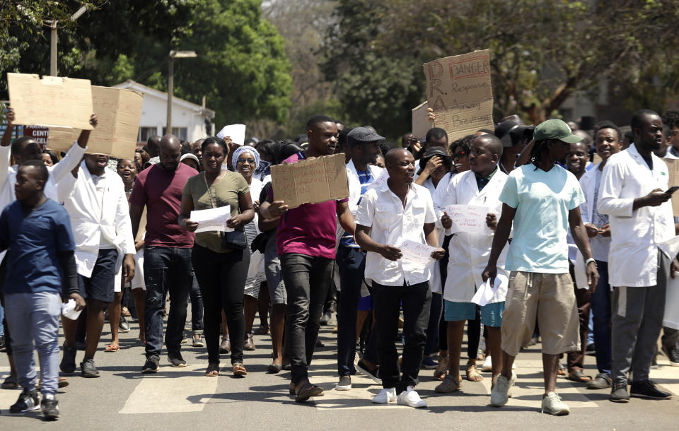 A group of Zimbabwean doctors protest at Parirenyatwa hospital in Harare, Zimbabwe, Sunday, Sept. 15, 2019. The Zimbabwe Hospital Doctors Association, which represents hundreds of junior doctors countrywide, said the association's president Peter Magombeyi was abducted on Saturday, days after receiving threats on his phone. (AP Photo/Themba Hadebe)