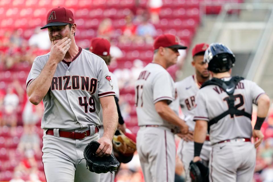 Arizona Diamondbacks starting pitcher Tyler Gilbert leaves during the second inning of the team's baseball game against the Cincinnati Reds on Tuesday, June 7, 2022, in Cincinnati. (AP Photo/Jeff Dean)