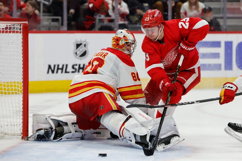 Flames goaltender Dan Vladar makes the save on Red Wings left wing Lucas Raymond in the second period of the Wings' 2-1 win on Thursday, Feb. 9, 2023, at Little Caesars Arena.