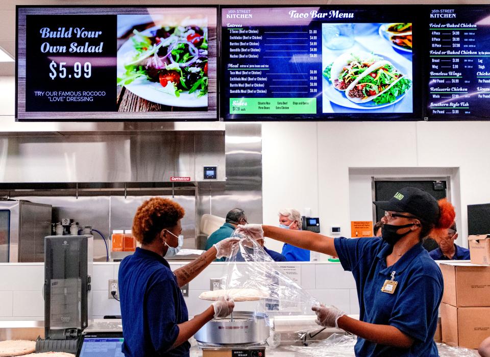 Staff members work Aug. 30, 2021, to make items in the deli at the new Homeland store at 625 NE 36 in Oklahoma City.