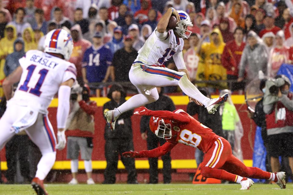 KANSAS CITY, MISSOURI - OCTOBER 10: Josh Allen #17 of the Buffalo Bills leaps over the defense of L'Jarius Sneed #38 of the Kansas City Chiefs during the second half of a game at Arrowhead Stadium on October 10, 2021 in Kansas City, Missouri.