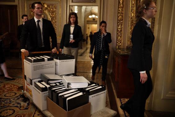 Stacks of legal papers are wheeled in ahead of the hearing (Getty)