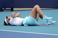 Bianca Andreescu of Canada falls to the court during her finals match against Ashleigh Barty of Australia at the Miami Open tennis tournament, Saturday, April 3, 2021, in Miami Gardens, Fla. Barty won 6-3, 4-0, as Andreescu retired due to injury. (AP Photo/Lynne Sladky)