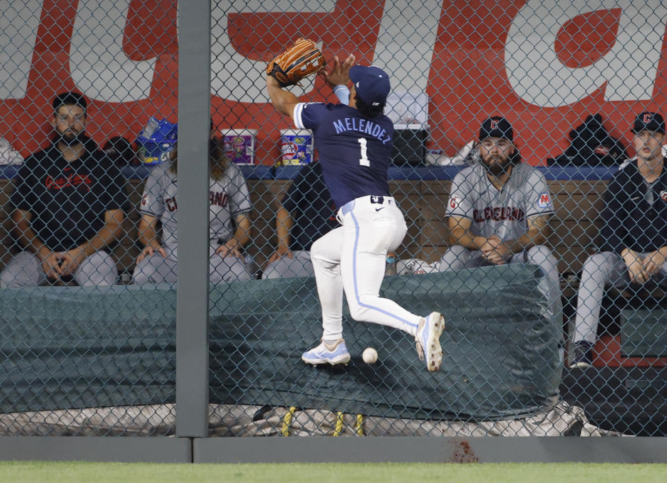 Kansas City Royals left fielder MJ Melendez runs into the left field fence as he is unable to catch a double by Cleveland Guardians' David Fry during the ninth of a baseball game in Kansas City, Mo., Friday, June 28, 2024. (AP Photo/Colin E. Braley)