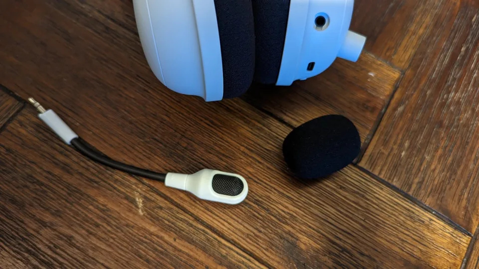 The microphone of the Razer Blackshark V2 Pro 2023 edition on a wooden table.