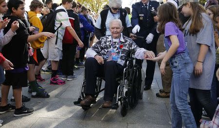 A U.S. military World War Two veteran is greeted by Lake Braddock School students from Virginia as they welcomed 22 veterans from the Greater St. Louis Honor Flight visiting the National World War II Memorial on Veteran's Day in Washington, November 11, 2014. REUTERS/Larry Downing