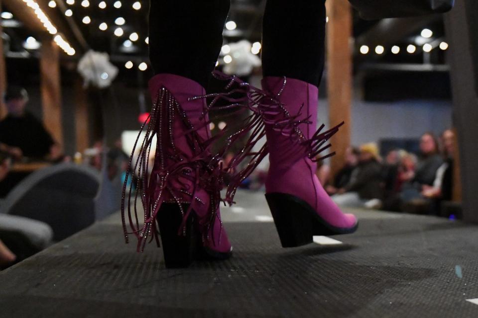 A model wears pink boots on the runway on Thursday, Nov. 9, 2023 at Icon Lounge in Sioux Falls, South Dakota.