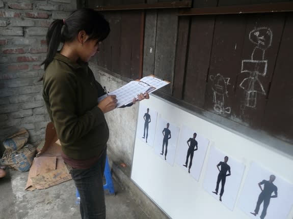 A volunteer with foot-size cut-outs similar to those used in the experiment. (The experimental images were female.)