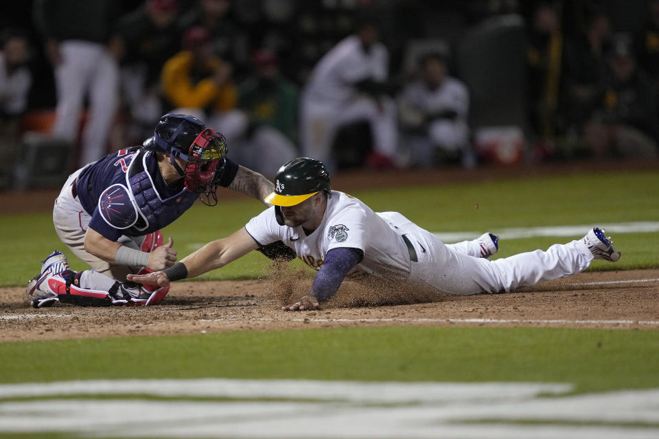 Boston Red Sox catcher Christian Vazquez tags out Oakland Athletics' Seth Brown at home plate during the 10th inning of a baseball game Friday, July 2, 2021, in Oakland, Calif. (AP Photo/Tony Avelar)