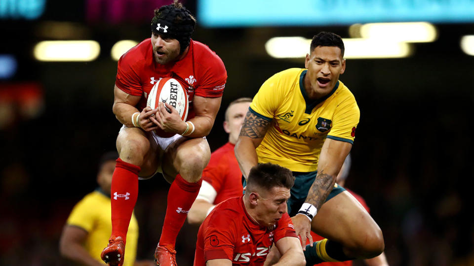 Leigh Halfpenny of Wales catches the ball ahead of Israel Folau of Australia, whilst Josh Adams of Wales is caught in between during the International Friendly match between Wales and Australia at Principality Stadium on November 10, 2018 in Cardiff, United Kingdom. (Photo by Michael Steele/Getty Images)