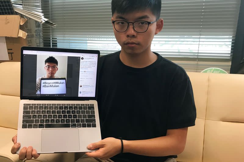 Pro-democracy activist Joshua Wong poses with his Twitter post in Hong Kong
