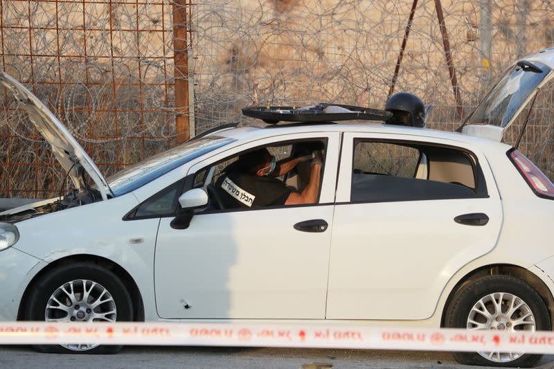 Israeli police sapper works inside a vehicle at the scene of what Israeli police said was an attempted car-ramming attack at a checkpoint in East Jerusalem