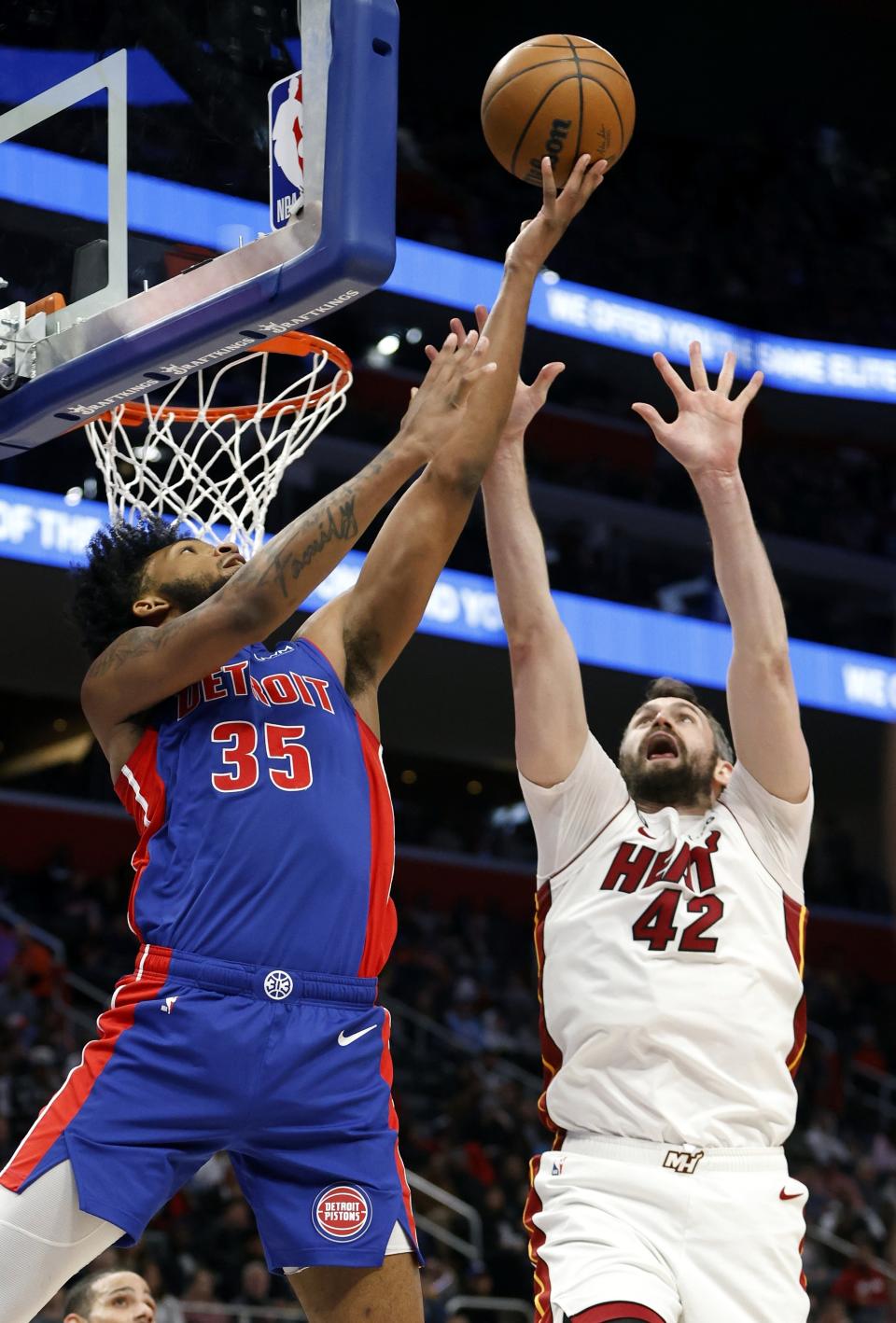 Detroit Pistons forward Marvin Bagley III (35) gets off a shot against Miami Heat forward Kevin Love (42) during the first half of an NBA basketball game, Sunday, March 19, 2023, in Detroit. (AP Photo/Duane Burleson)