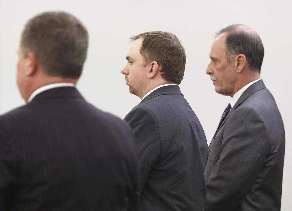 Aaron Dean, center, stands with his defense team as Judge George Gallagher reads his sentence on Tuesday, Dec. 20, 2022, at Tarrant County's 396th District Court at the Tim Curry Criminal Justice Center in Fort Worth, Texas. Former Fort Worth police officer Dean was sentenced to nearly 12 years after being convicted of manslaughter in the 2019 killing of Atatiana Jefferson. (Amanda McCoy/Star-Telegram via AP, Pool)