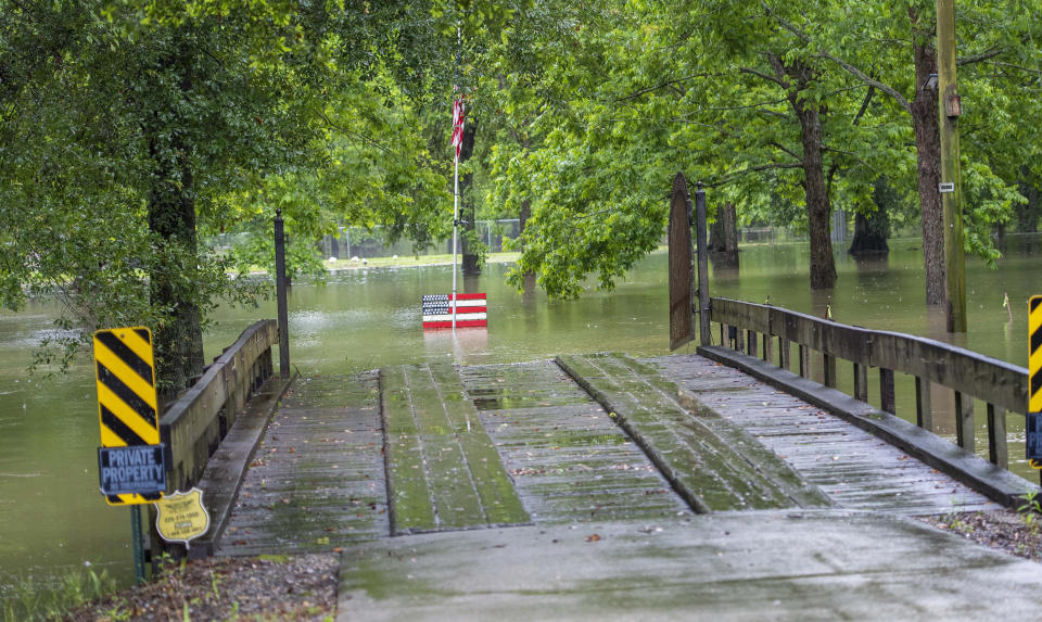 A wooden bridge leads to a flooded area along Bluff Road Tuesday, May 18, 2021, in Ascension Parish, La. Heavy rains have swept across southern Louisiana, flooding homes, swamping cars and closing a major interstate. (Bill Feig/The Advocate via AP)