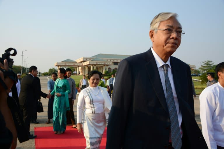 Myanmar's President Htin Kyaw (R), followed by First Lady Su Su Lwin (in white dress) and State Counsellor and Foreign Minister Aung San Suu Kyi (in green dress), depart for an official trip to Laos, from the Naypyidaw city airport, on May 6, 2016