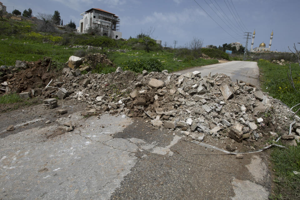 A bypass road that connects Ramallah with neighboring villages, is closed with rubble by Palestinian security forces to enforce new government measures against the coronavirus, near the West Bank city of Ramallah, Monday, March 23, 2020. On Sunday, Palestinian Prime Minister Mohammad Shtayyeh declared a two week set of strict precautionary measures that include confining residents to their homes, restricting movement between cities and deploying security forces, along with other measures to contain the COVID-19 outbreak. (AP Photo/Nasser Nasser)