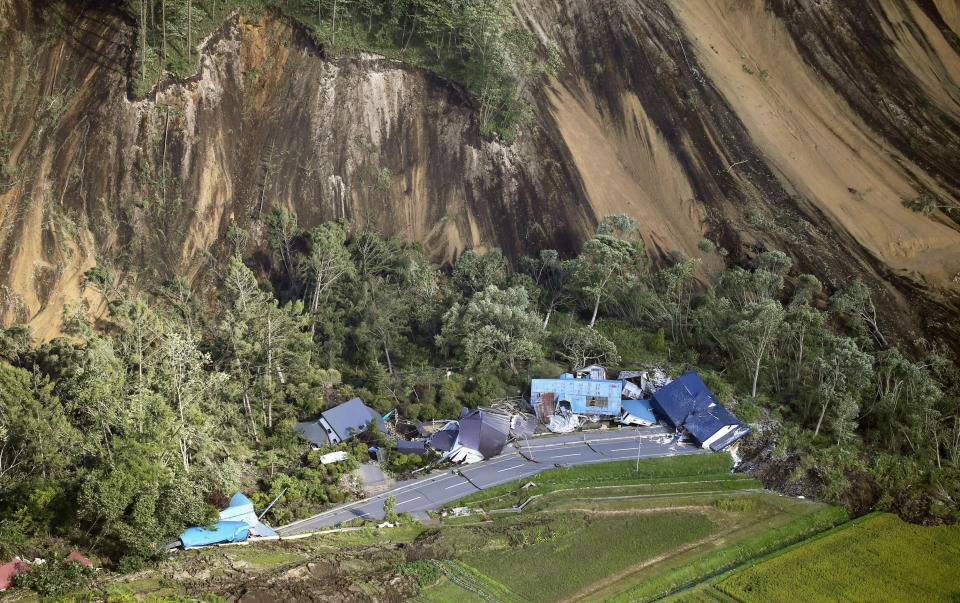 This aerial photo shows houses destroyed by a landslide after an earthquake in Atsuma town, Hokkaido, northern Japan, Thursday, Sept. 6, 2018. A powerful earthquake rocked Japan’s northernmost main island of Hokkaido early Thursday, triggering landslides that crushed homes, knocking out power across the island, and forcing a nuclear power plant to switch to a backup generator. (Kyodo News via AP)