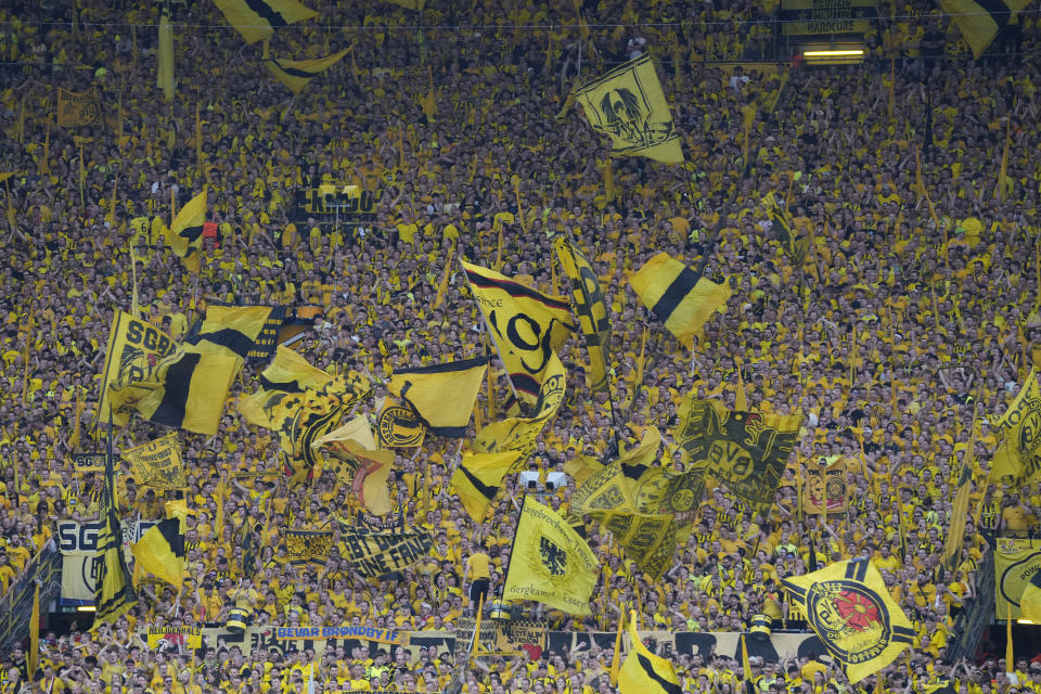 Supporters cheer before the Champions League semifinal first leg soccer match between Borussia Dortmund and Paris Saint-Germain at the Signal-Iduna Park stadium in Dortmund, Germany, Wednesday, May 1, 2024. (AP Photo/Matthias Schrader)