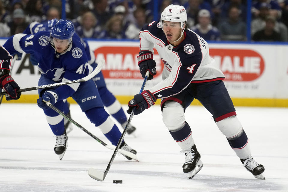 Columbus Blue Jackets center Cole Sillinger (4) breaks out ahead of Tampa Bay Lightning right wing Mitchell Chaffee (41) during the first period of an NHL hockey game Tuesday, April 9, 2024, in Tampa, Fla. (AP Photo/Chris O'Meara)
