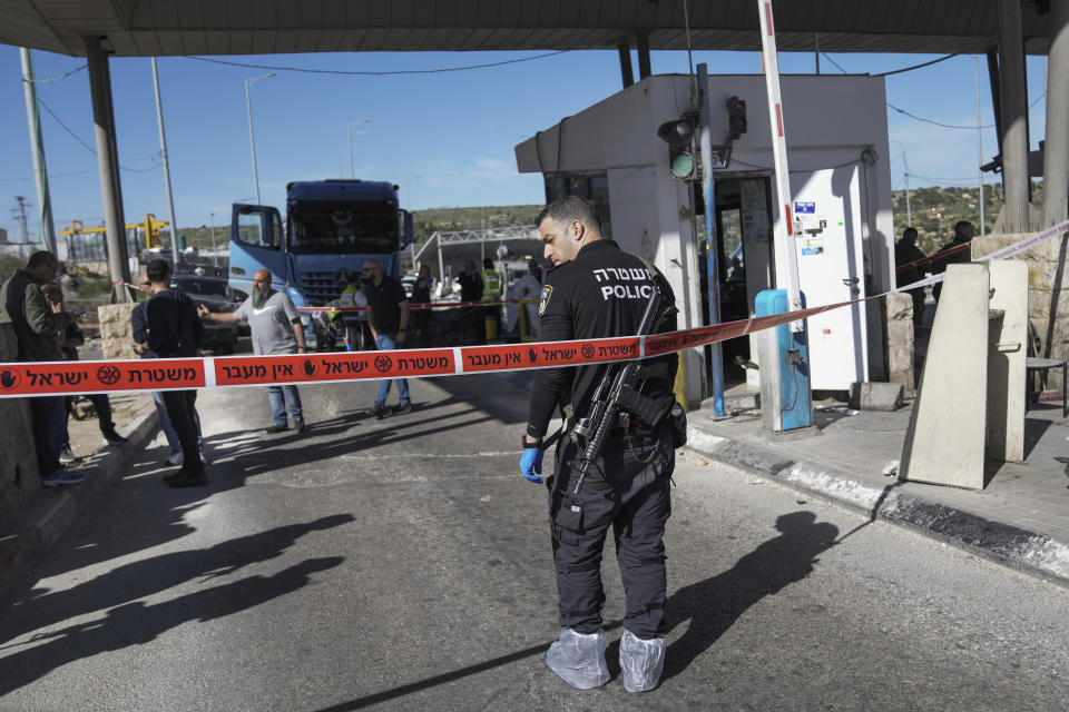 Israeli security forces inspect the scene of a stabbing attack at a checkpoint between Jerusalem and the West Bank on Wednesday, March 13, 2024. A Palestinian stabbed and wounded two people at a checkpoint near Jerusalem before being shot and killed. (AP Photo/Mahmoud Illean)