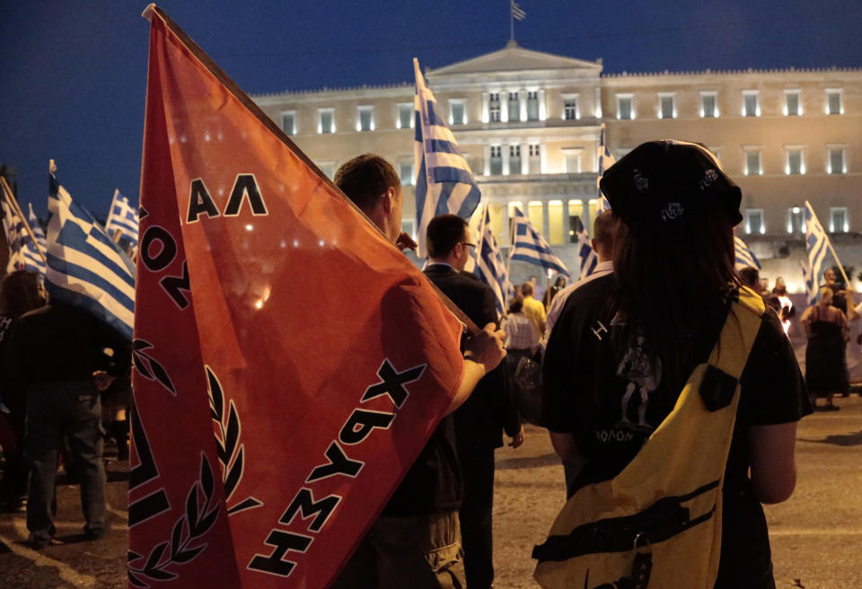 Members and supporters of the extreme right party Golden Dawn march in front of the Greek Parliament in central Athens on Wednesday May 29, 2013, during a rally marking the anniversary of the fall of Constantinople to the Ottoman Empire in 1453. (AP Photo/Dimitri Messinis)