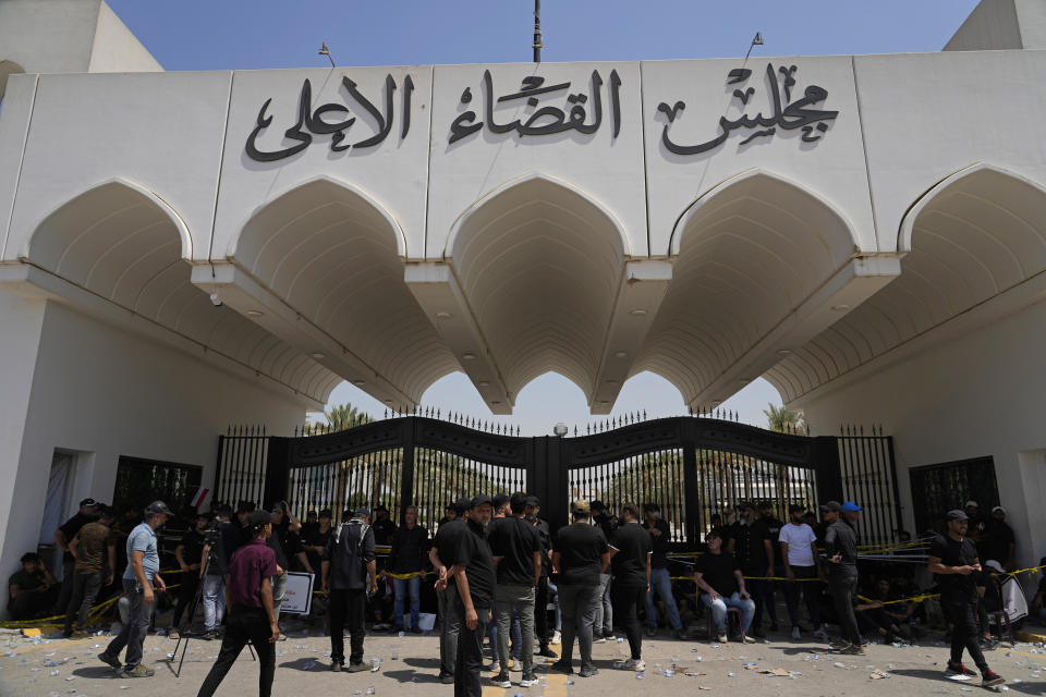 Supporters of Iraqi Shiite cleric Muqtada al-Sadr protest in front an entrance to the Supreme Judicial Council, in Baghdad, Iraq, Tuesday, Aug. 23, 2022. Dozens of supporters of al-Sadr, an influential Shiite cleric in Iraq, rallied on Tuesday in Baghdad’s heavily-fortified Green Zone, demanding the dissolution of parliament and early elections. The demonstration underscored how intractable Iraq's latest political crisis has become. (AP Photo/Hadi Mizban)