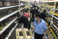 Residents rush to stock up on necessities at a supermarket after authorities lockdown near residential blocks to prevent the spread of the COVID-19 in Wuhan city in central China's Hubei province Monday, Aug. 2, 2021. Chinese authorities announced Tuesday the mass testing of Wuhan as an unusually wide series of COVID-19 outbreaks reached the city where the disease was first detected in late 2019. (Chinatopix via AP)