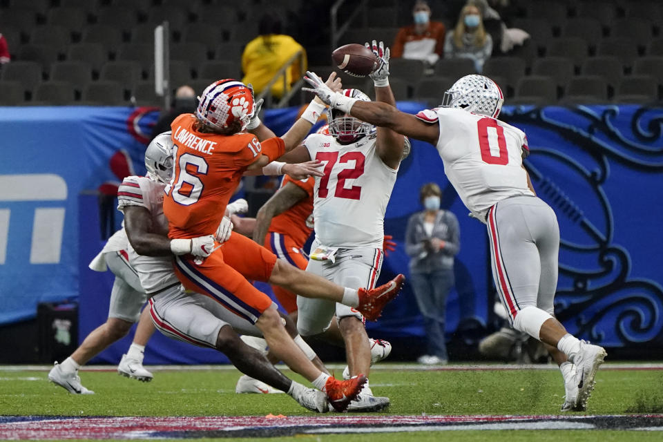 Ohio State defensive tackle Tommy Togiai (72) blocks a pass by Clemson quarterback Trevor Lawrence during the second half of the Sugar Bowl NCAA college football game Friday, Jan. 1, 2021, in New Orleans. (AP Photo/Gerald Herbert)