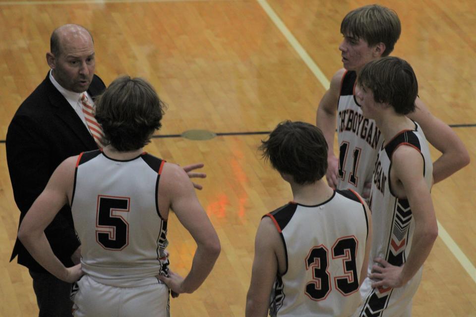 Cheboygan head coach Jason Friday talks to Caden Gardner (5), Ethan Gibbons (33), Kaleb Goodrich (4) and Brennen Thater (11) during a timeout in the second half on Wednesday.