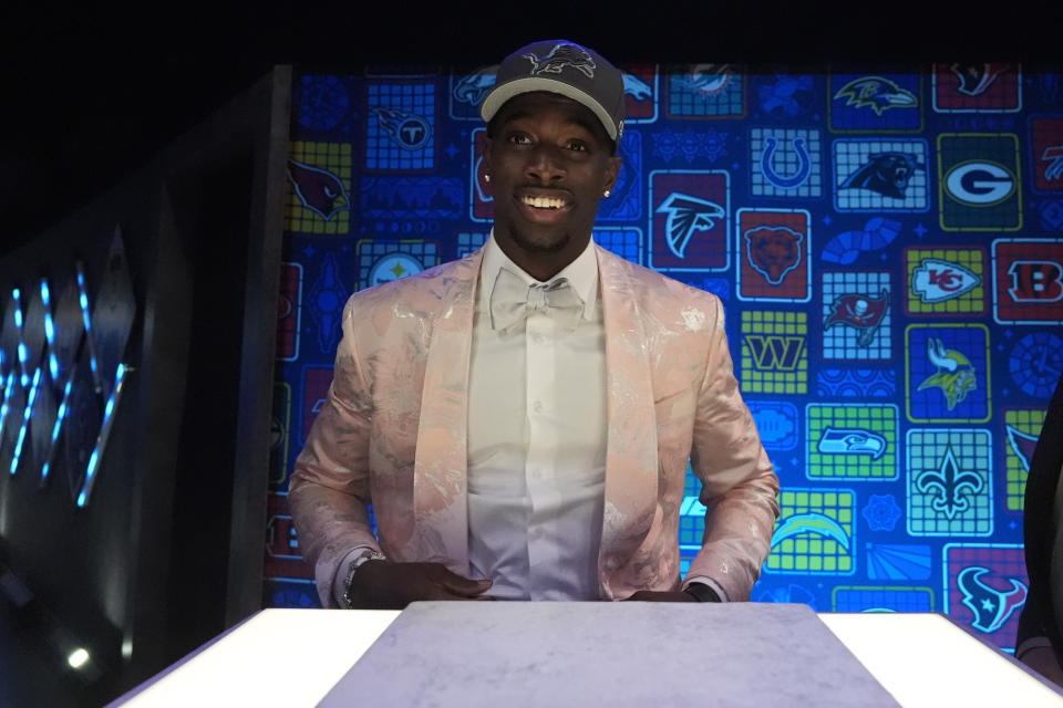 Alabama cornerback Terrion Arnold puts on a hat after being chosen by the Detroit Lions with the 24th overall pick during the first round of the NFL football draft, Thursday, April 25, 2024, in Detroit. (AP Photo/Jeff Roberson)