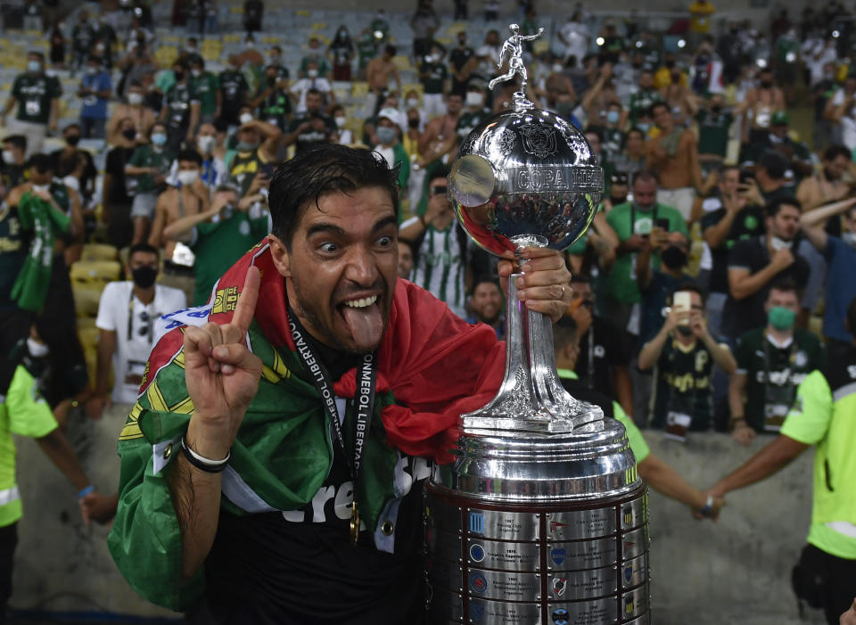 Coach Abel Ferreira of Brazil's Palmeiras celebrates with the trophy after winning the Copa Libertadores final soccer match against Brazil's Santos at the Maracana stadium in Rio de Janeiro, Brazil, Saturday, Jan. 30, 2021. Palmeiras won 1-0. (Mauro Pimentel/Pool via AP)