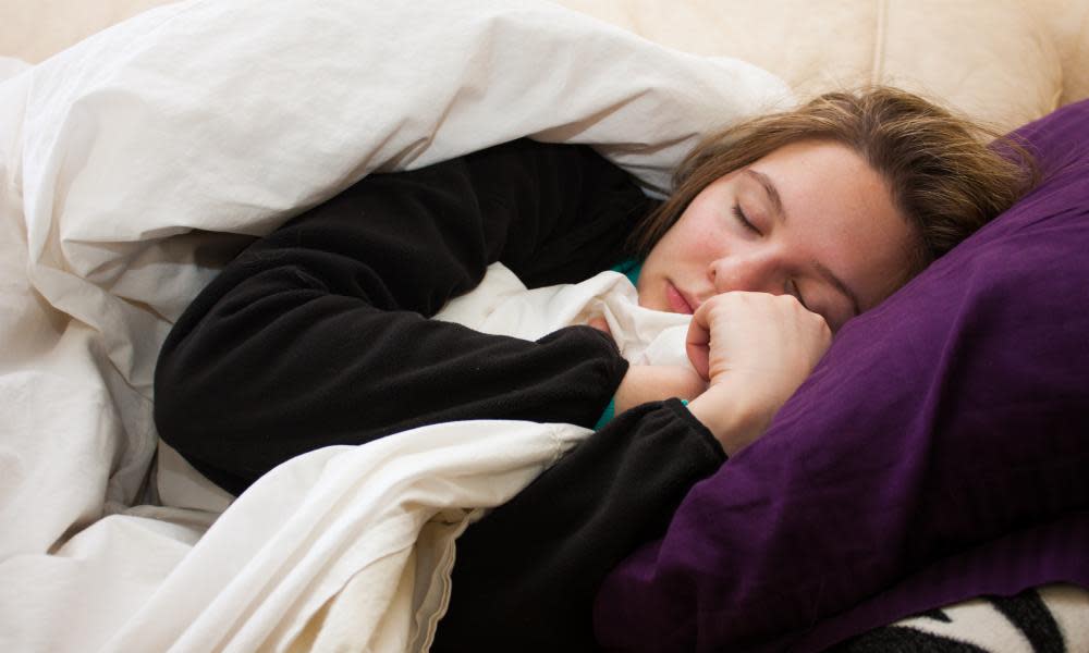 A woman curled up in a blanket