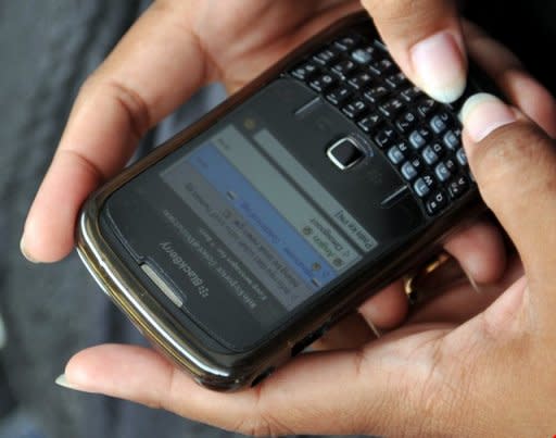 A woman uses her BlackBerry phone. Computer scientists have developed a mobile phone app that can predict the tone of incoming messages before a user reads them so that they are not caught off guard by angry or hostile words